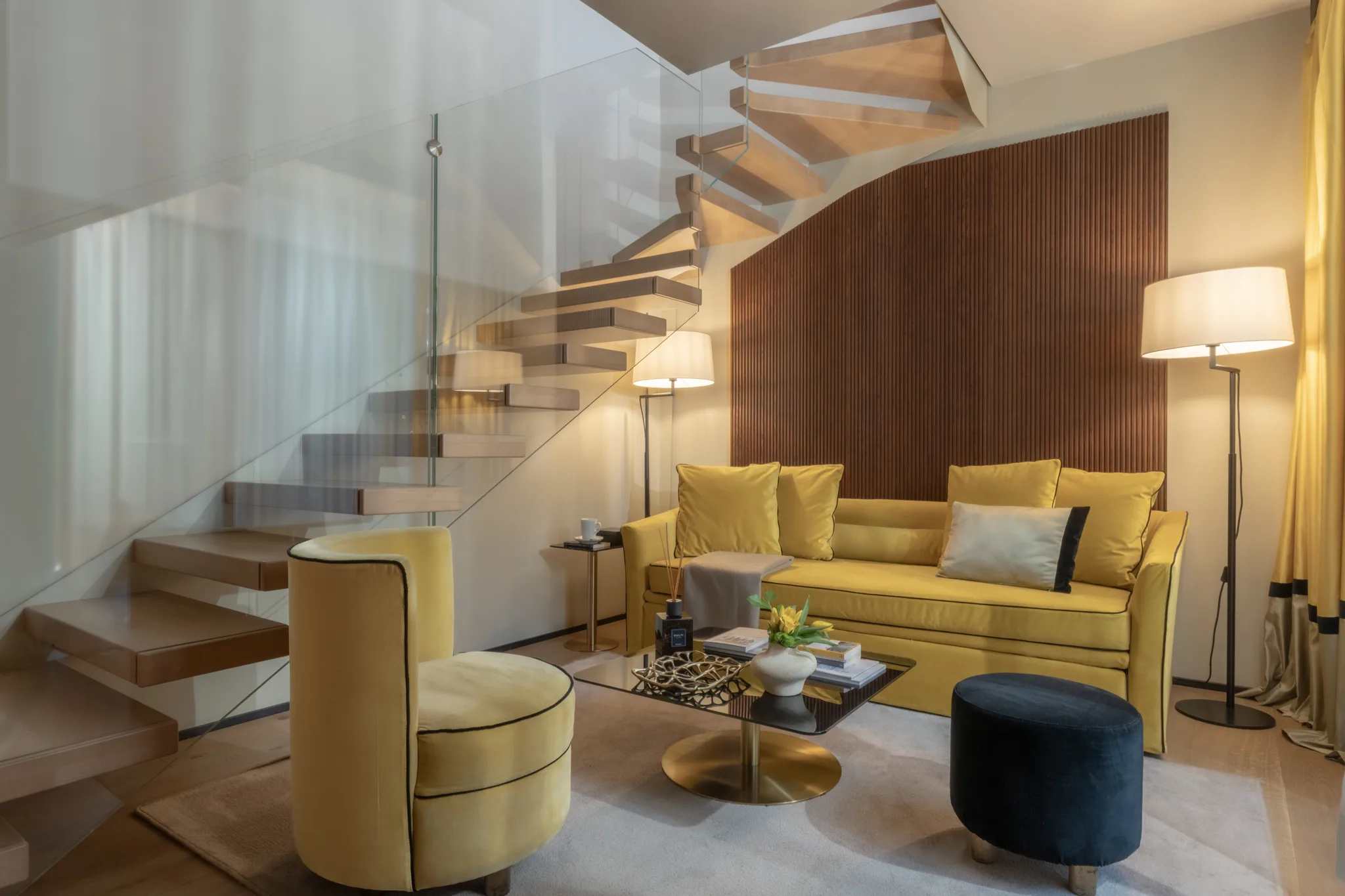 A duplex suite at Speronari — walnut stairs, gold velvet, afternoon light